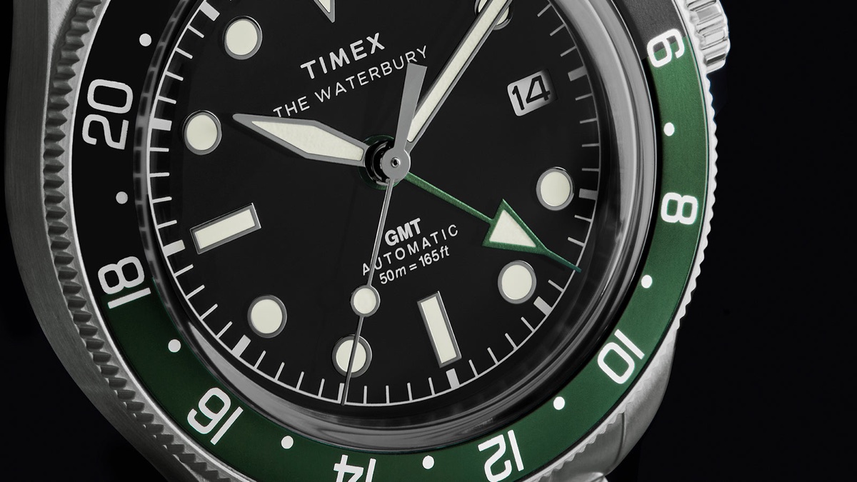 Detailed view of Timex Waterbury Heritage Automatic GMT watch dial with luminous markers and GMT hand.