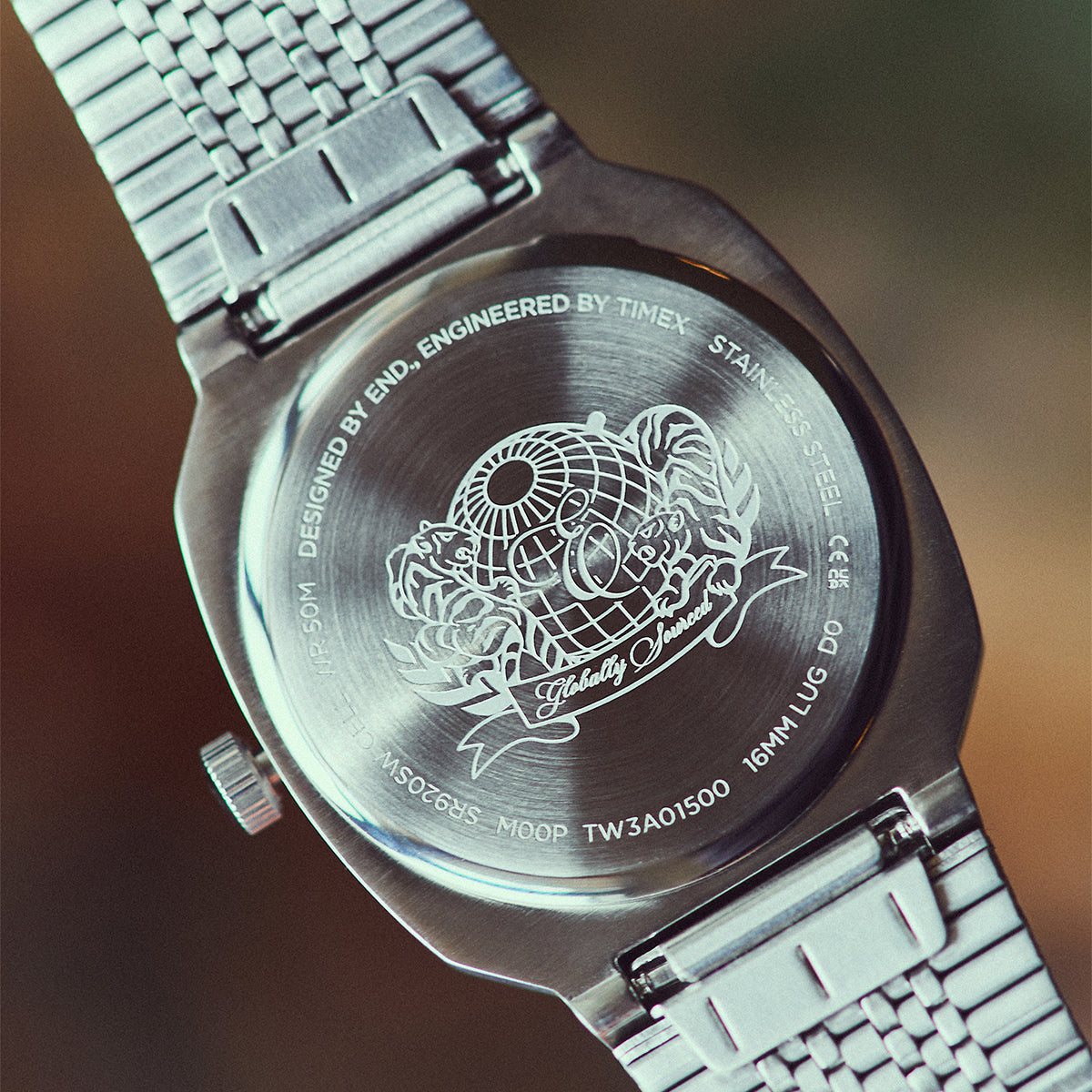 Caseback of the END. x Timex 1981 Reissue Inspired watch featuring an engraved globe and tiger design.