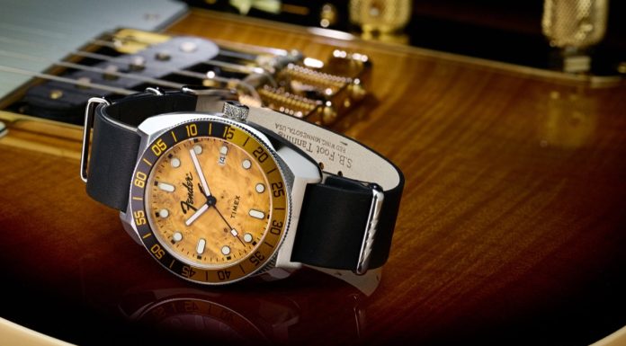 Timex x Fender: három órával ünneplik a Telecaster évfordulóját Fender x Timex Automatic watch with a silver-tone case, amber wood-grain dial, black-and-gold bezel, and black leather strap displayed on a Fender guitar.