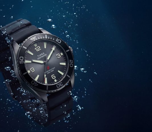 Timex Deepwater Arctic 200: dégradé számlappal frissül a retro búváróra TW3A02000 Deepwater Arctic 200 watch with a gray dial and black strap surrounded by underwater bubbles.